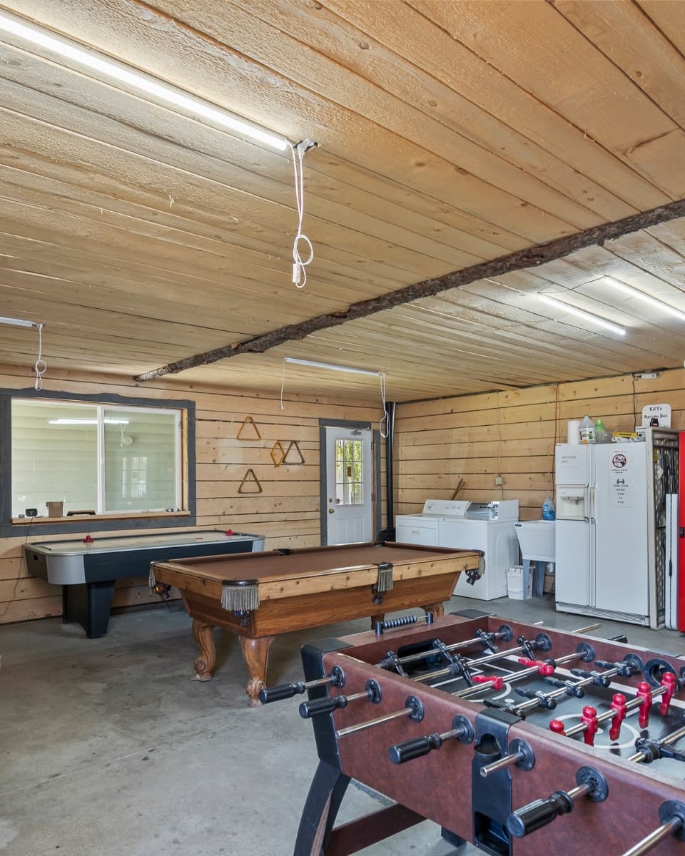 Game and laundry room with pool table, foosball, air hockey and washer-dryer at Birch Glen Lodge
