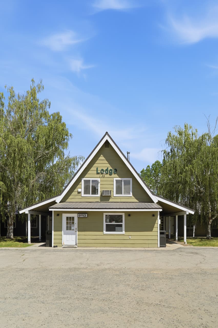 Front of the green A-frame lodge and office building at Birch Glen Lodge in Cascade, Idaho